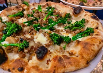 Dolomiti Pizzeria and Enoteca Rustica pizza topped with spicy sausage and charred broccolini