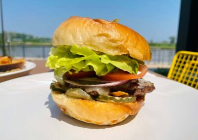 the burger at fig, show outside on a table overlooking the missouri river outside the luminarium
