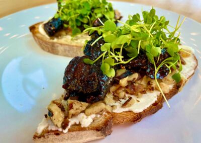 toast with figs. ricotta chèvre spread topped with balsamic and sprouts