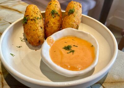 three saffron fritters and sauce