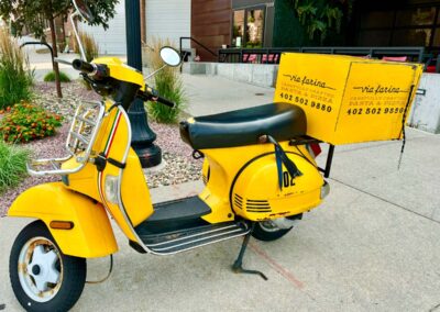 A yellow pizza delivery scooter