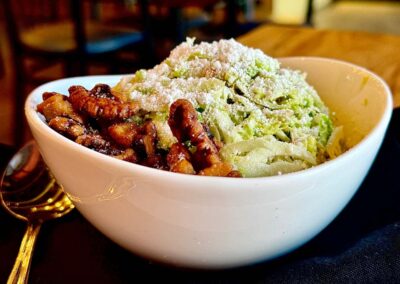 a bowl with salad and candied walnuts, the shaved brussels