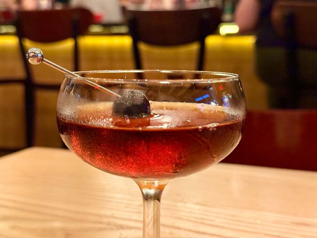 a cocktail with a cherry, the smooth operator