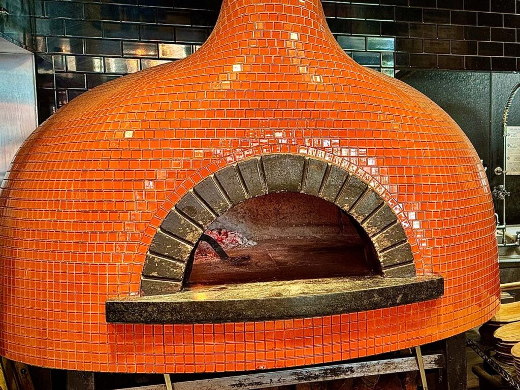 A large, orage wood-fired pizza oven