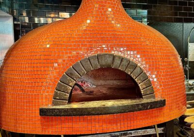 A large, orage wood-fired pizza oven