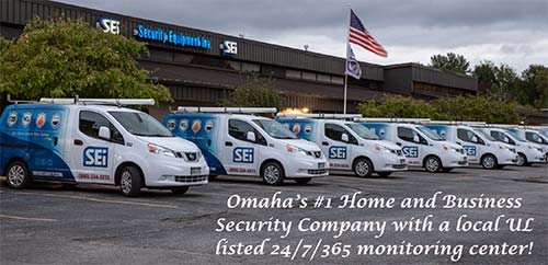 SEi Security ad with a shot of the building and service vehicles with the caption "Omaha's #1 home and business security company with a local UL Listed 24/7/365 monitoring center"