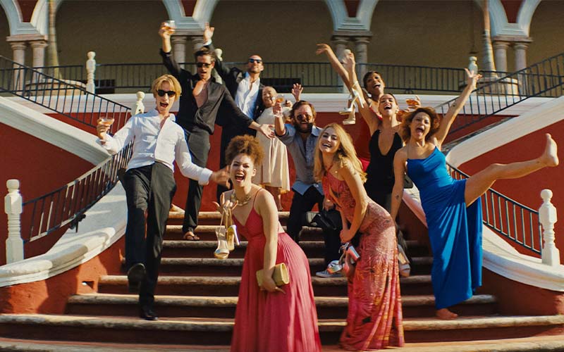 blink twice review featured image with entire cast in party poses on private island stairwell