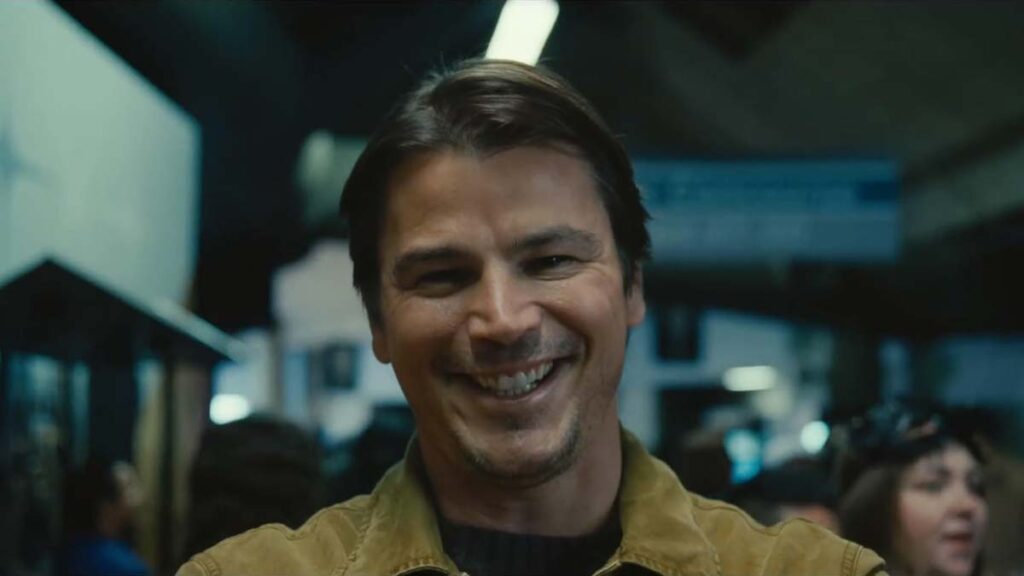 Josh Hartnett as serial killer Cooper Adams, also known as The Butcher, smiling creepy at the camera