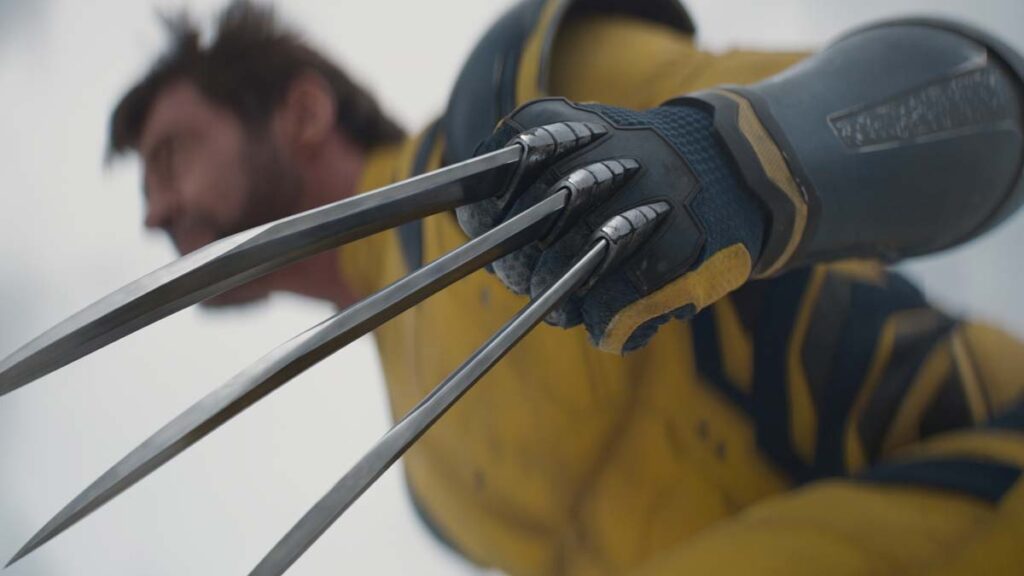 Wolverine stands poised and ready to fight with his claws out