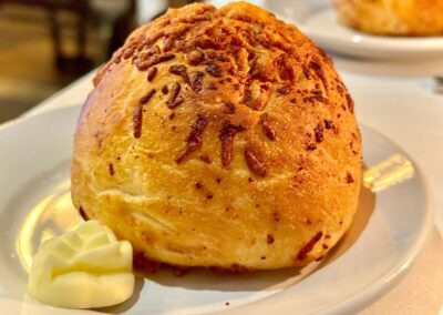 Dolce bread service, a large dinner roll with crusted cheese