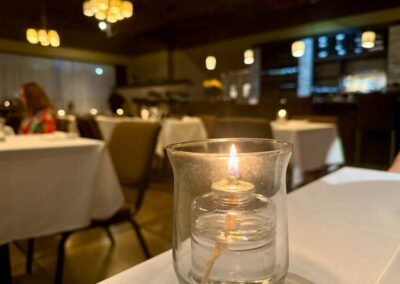 Dolce dining area with a table candle in front