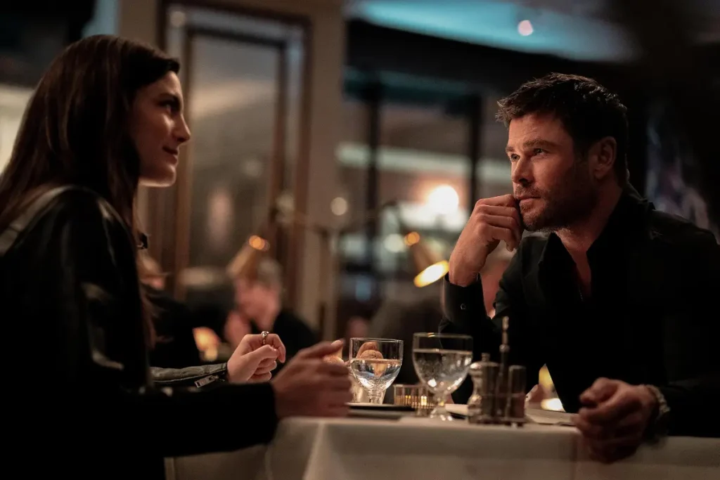 Monica Barbaro as Maya and Chris Hemsworth as Davis