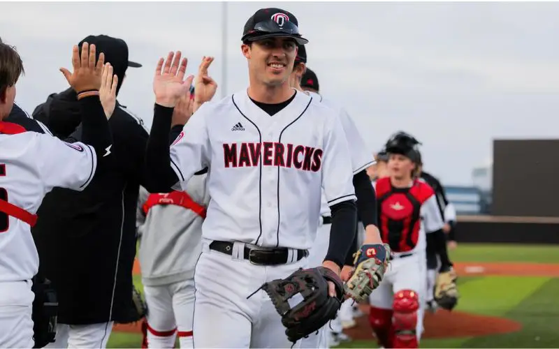 Omaha Mavericks baseball player with  glove taking the field