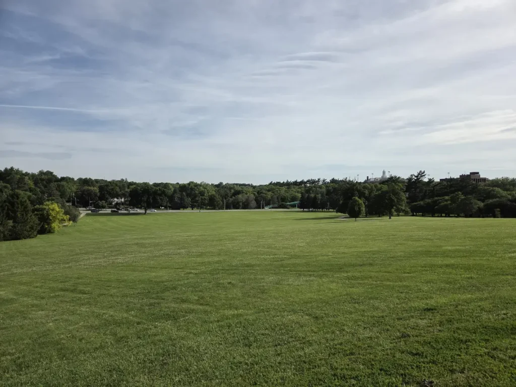 2026 photo of Memorial Park looking south from the memorial. The Dodge Street Overpass can be seen on the right. Behind it is UNO.