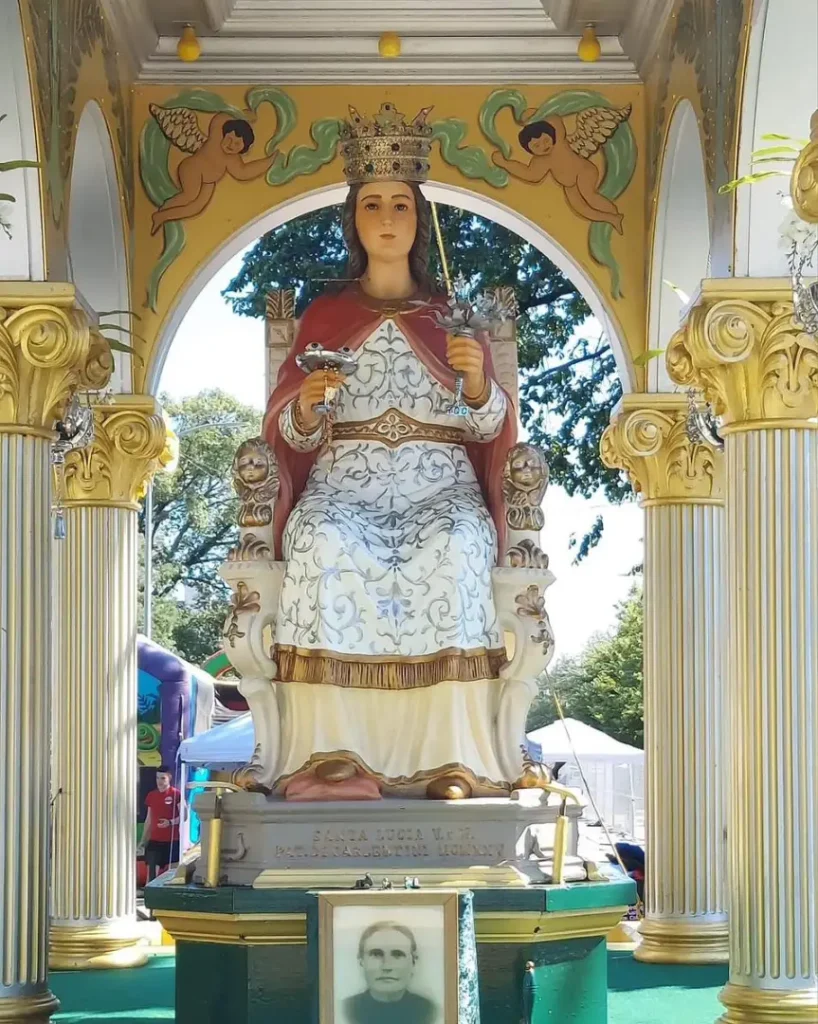 Closeup of the Santa Lucia statue and a photo of Grazia Bonafede Caniglia.